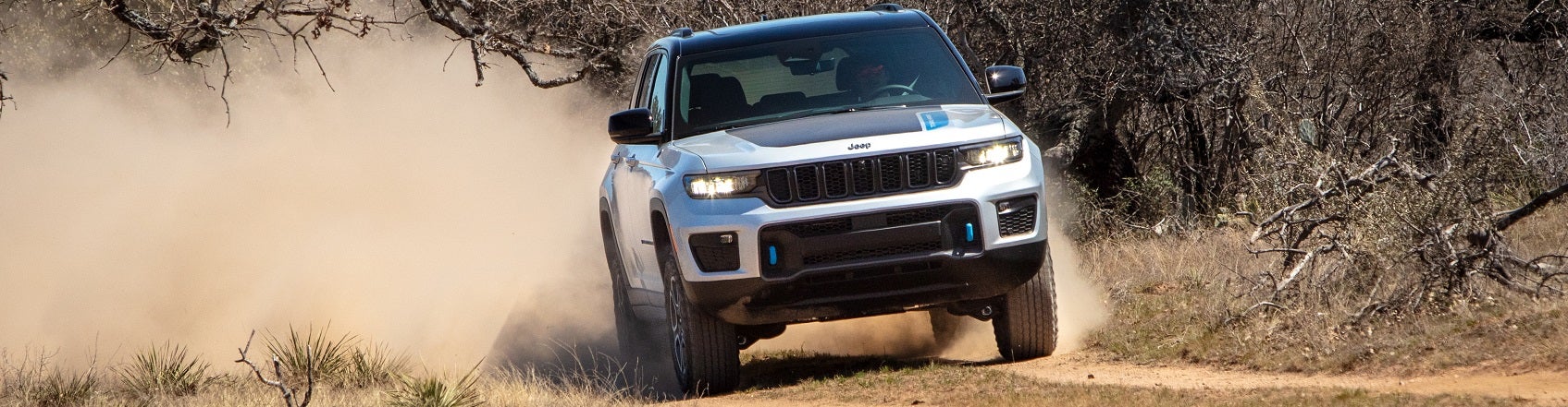 Jeep SUV driving on a dirth path in the desert