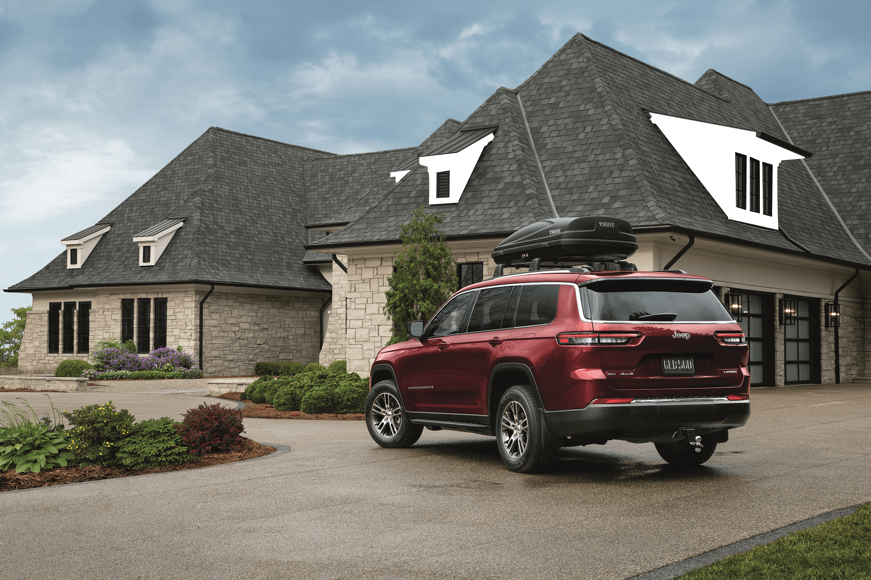 Jeep SUV parked on a driveway in front of a house